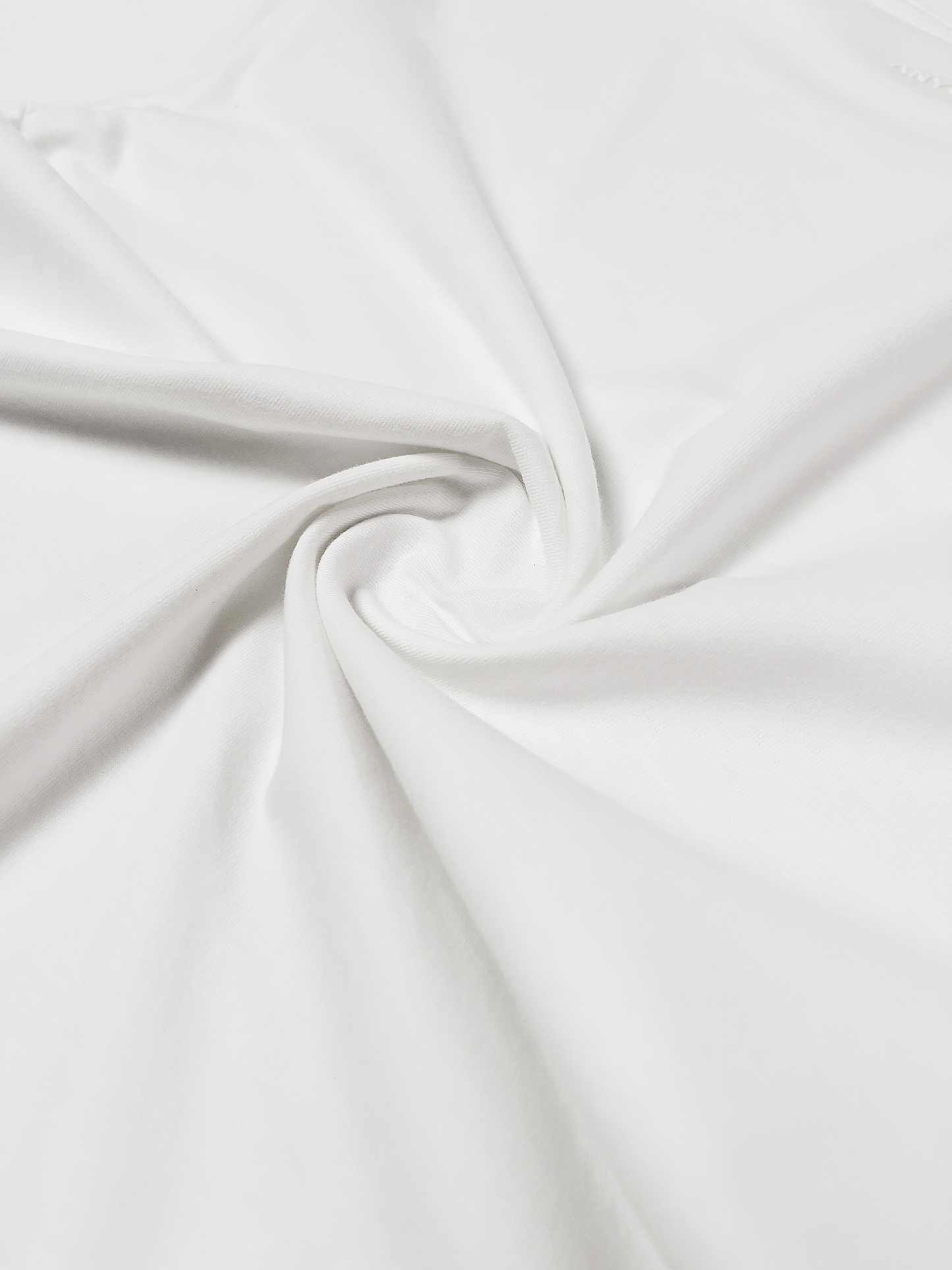Close-up of the ANYOBASE Core Tee in Off-White fabric.
