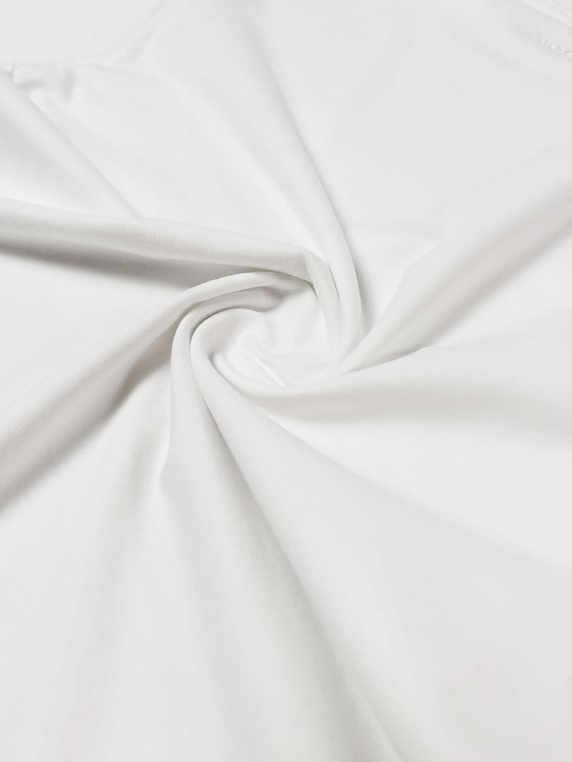 Close-up of the ANYOBASE Core Tee in Off-White fabric.