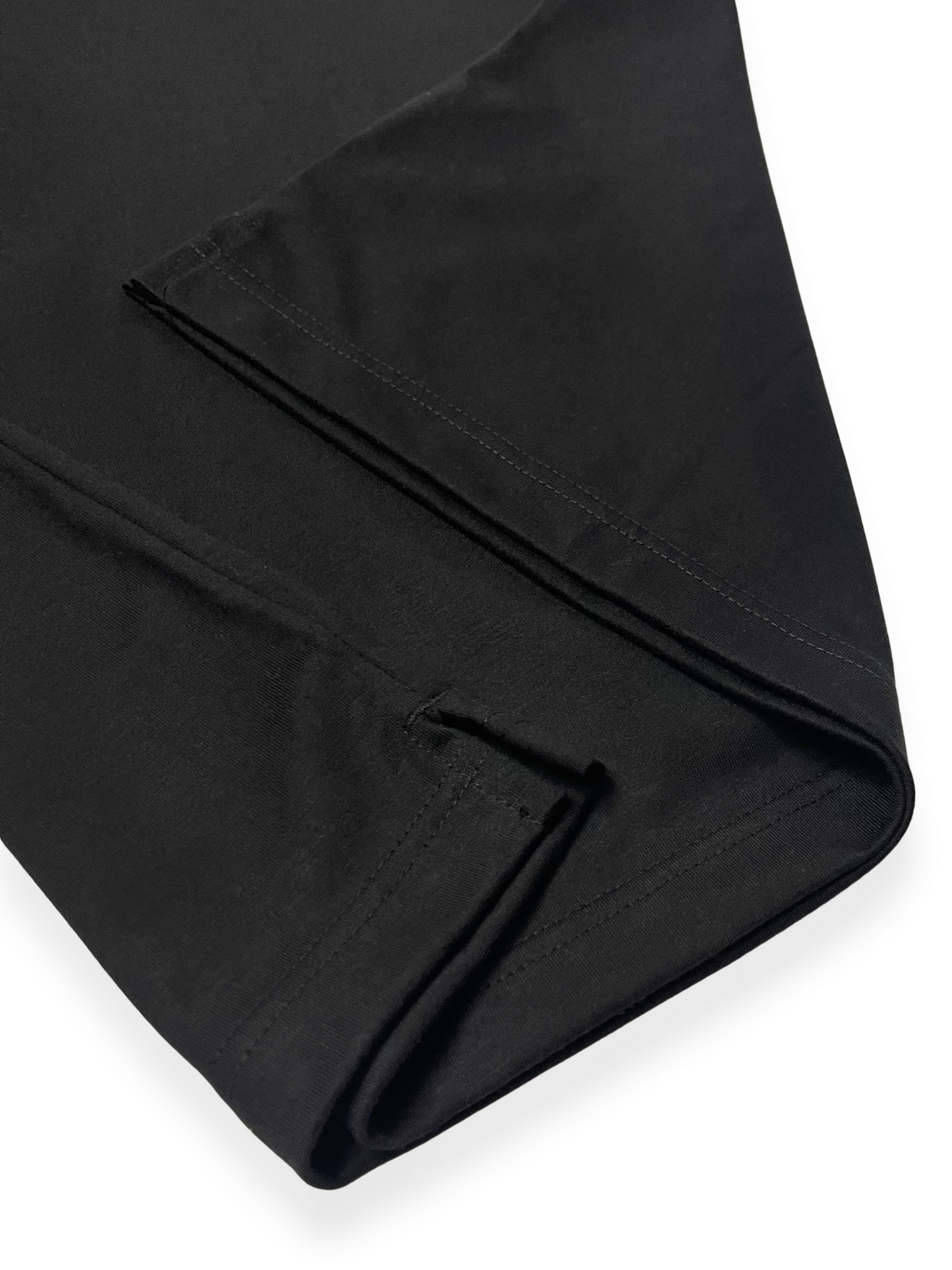 Close-up of the side slit detail on the ANYOBASE Core Tee in Black.